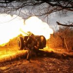 Ukrainian service members fire a howitzer D30 at a front line near the city of Bakhmut